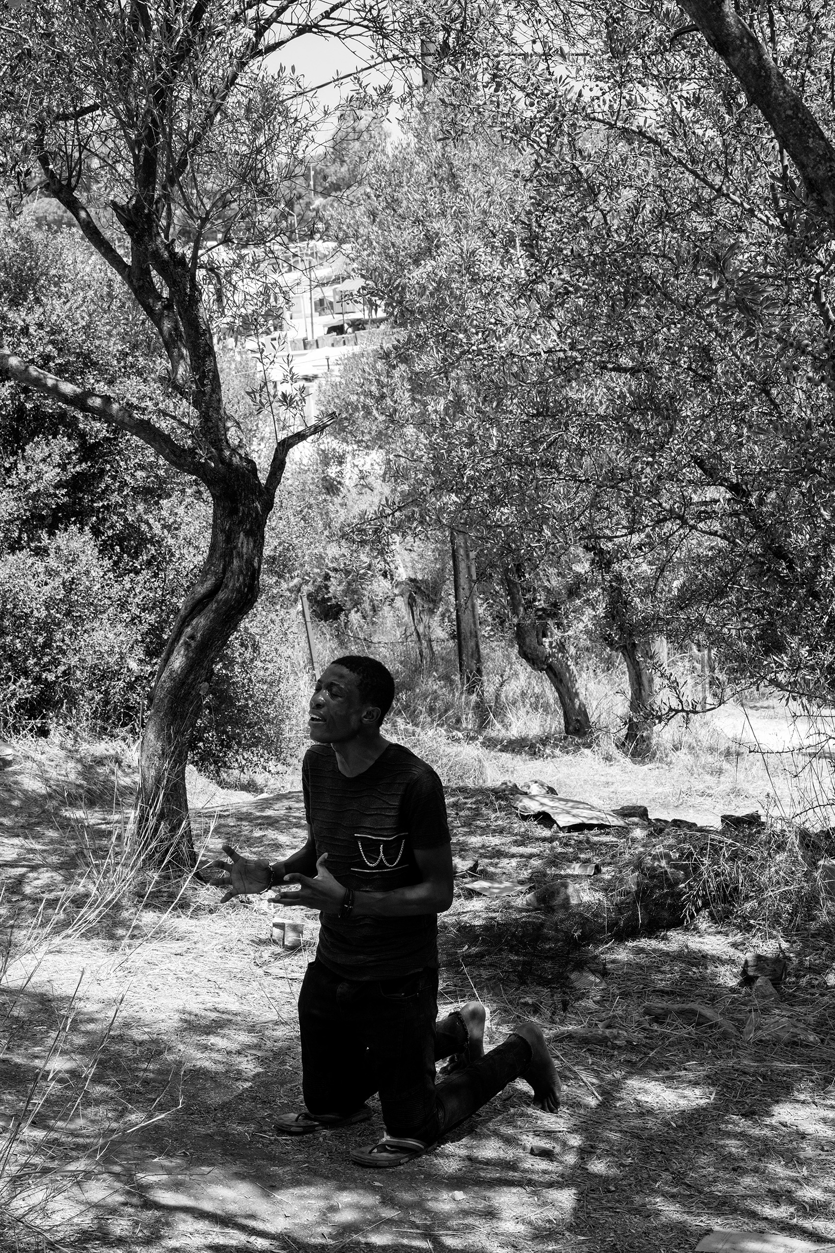 A priest from Nigeria prays outside the refugee camp Moria, Lesvos, Greece.