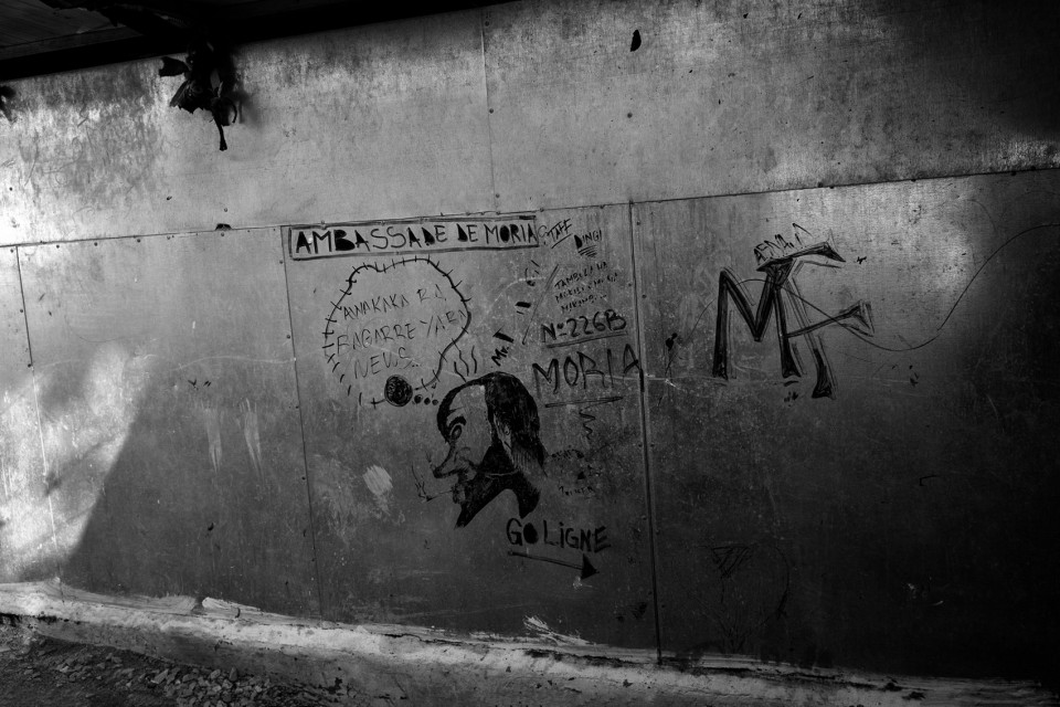 Graffiti at the back of showers inside the refugee camp Moria, Lesvos, Greece